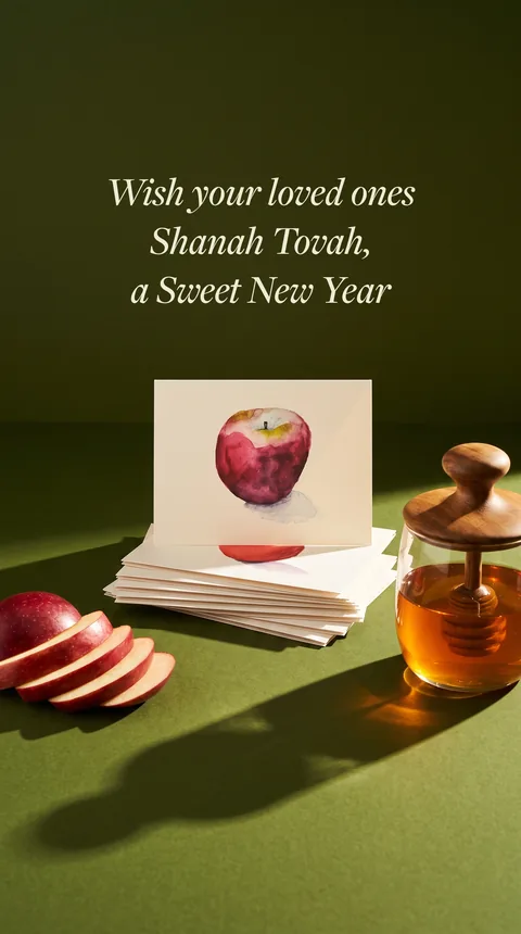 Ad: greeting card and honey jar on green, Wish your loved ones Shanah Tovah.