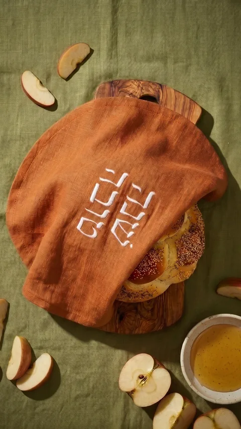 Ad: the cinnamon challah cover over bread with apples and honey.