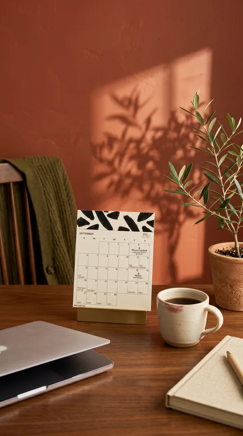 Ad: the 5787 calendar on a home office desk.